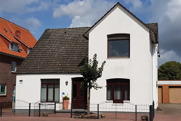 Weißes modernes Haus mit kleinem Vorgarten
